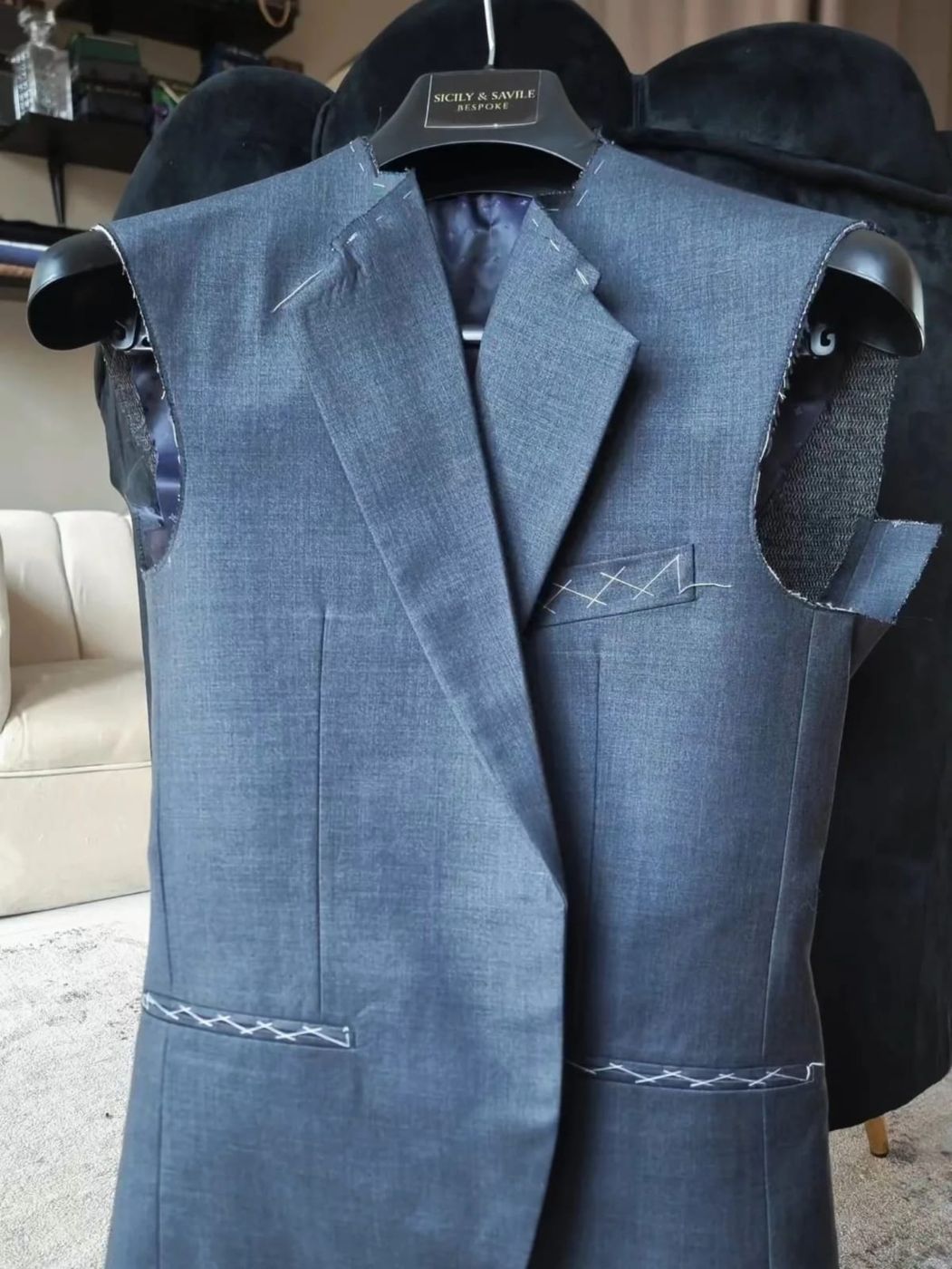A jacket marked with white tacking for adjustment