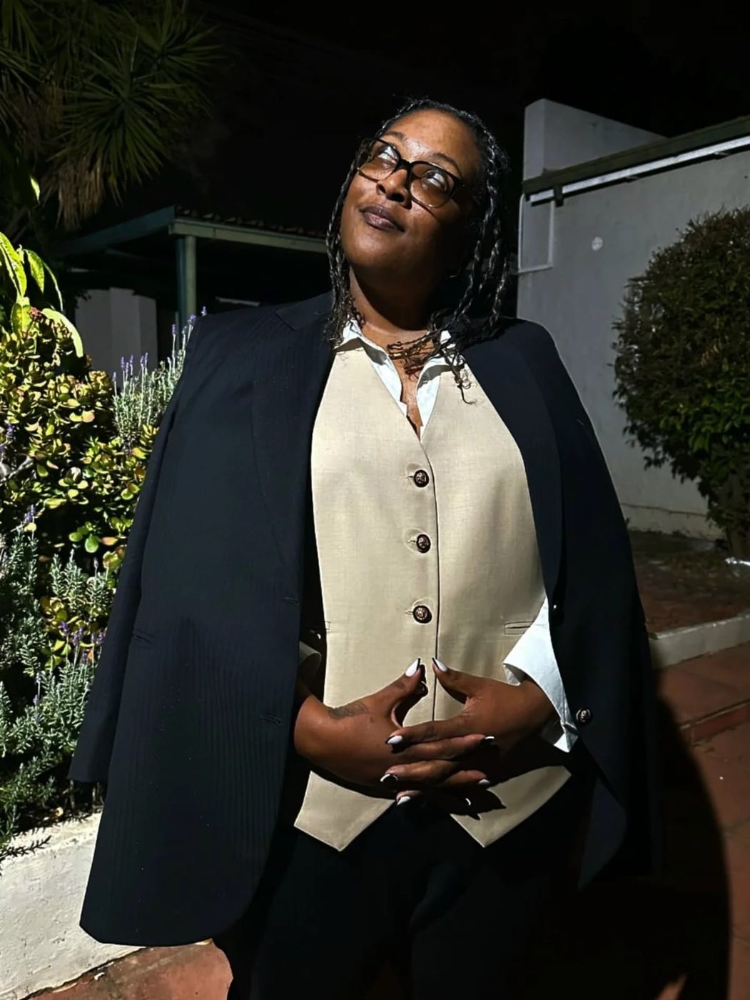 A client smiling in her tailored waistcoat and jacket