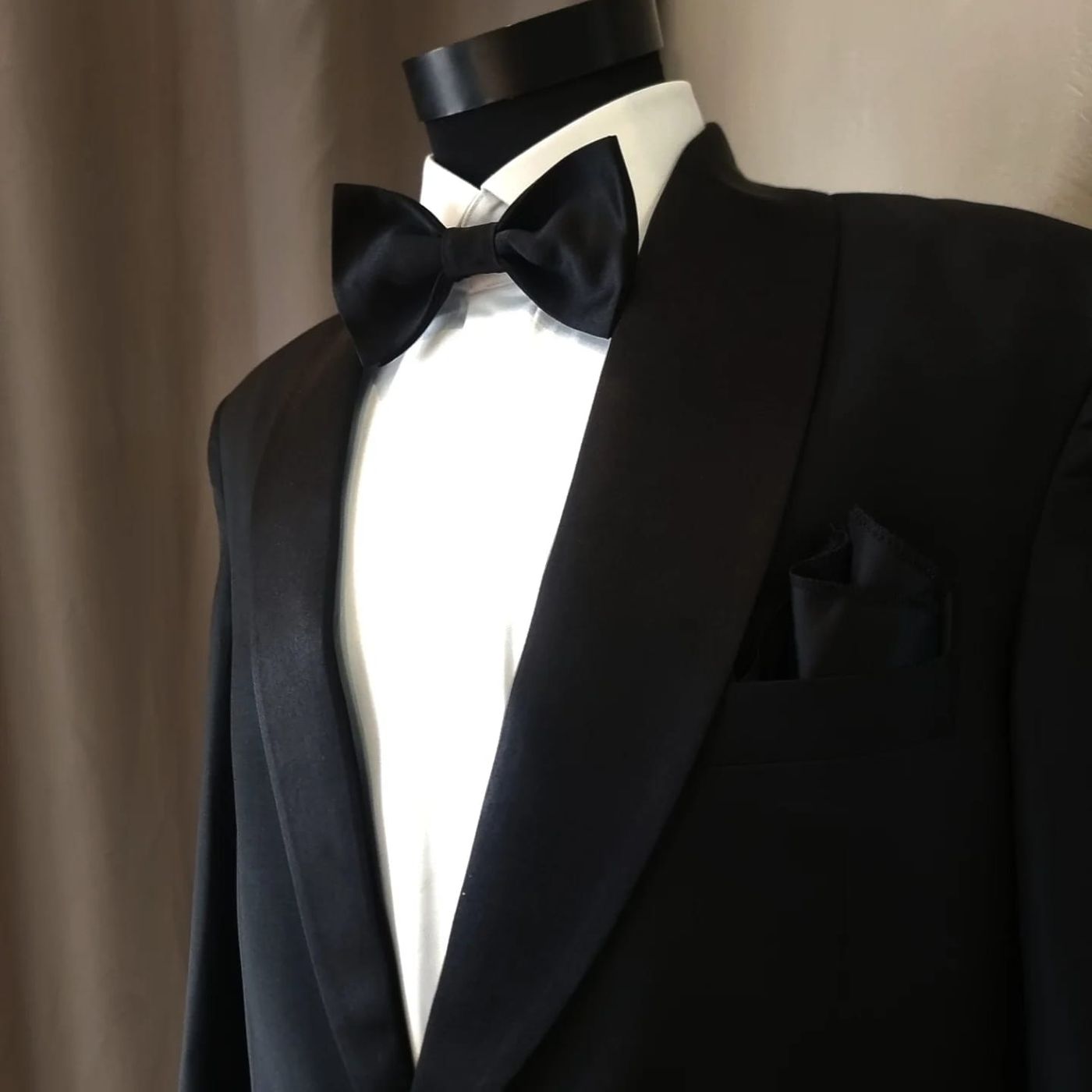 A black shawl-collar tuxedo with a silk bow tie