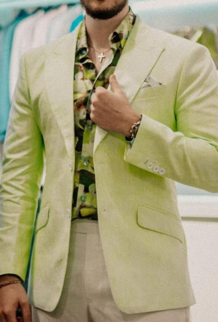 A pistachio linen jacket worn open over a printed shirt