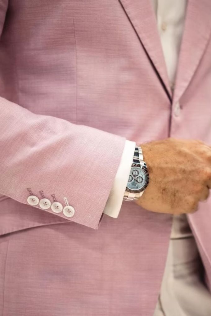 A rose linen jacket over a white shirt cuff