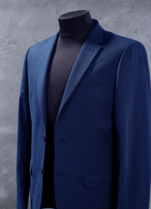 A clean navy single-breasted jacket on a stand