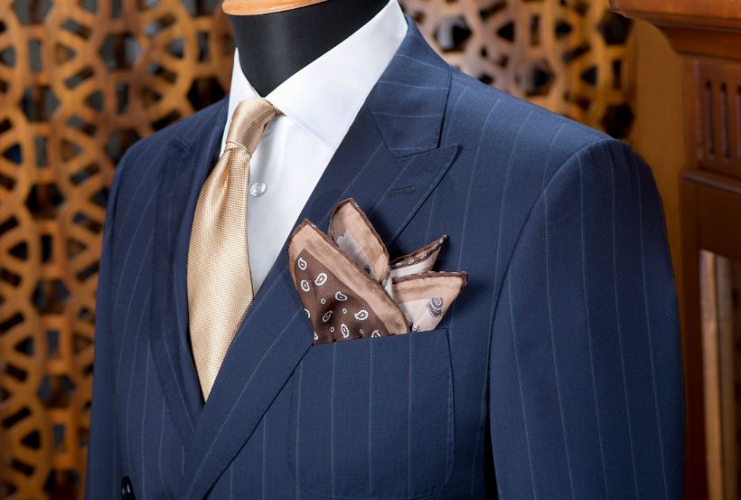 Navy chalk-stripe double-breasted jacket with a gold tie