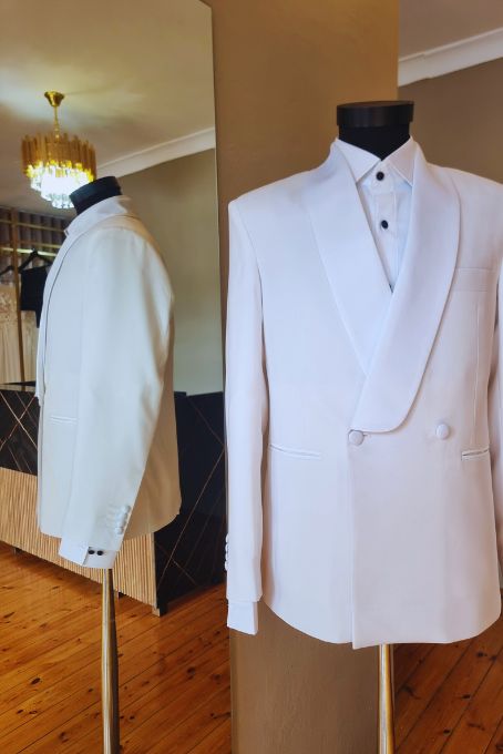 Ivory double-breasted shawl-collar dinner jacket on a stand